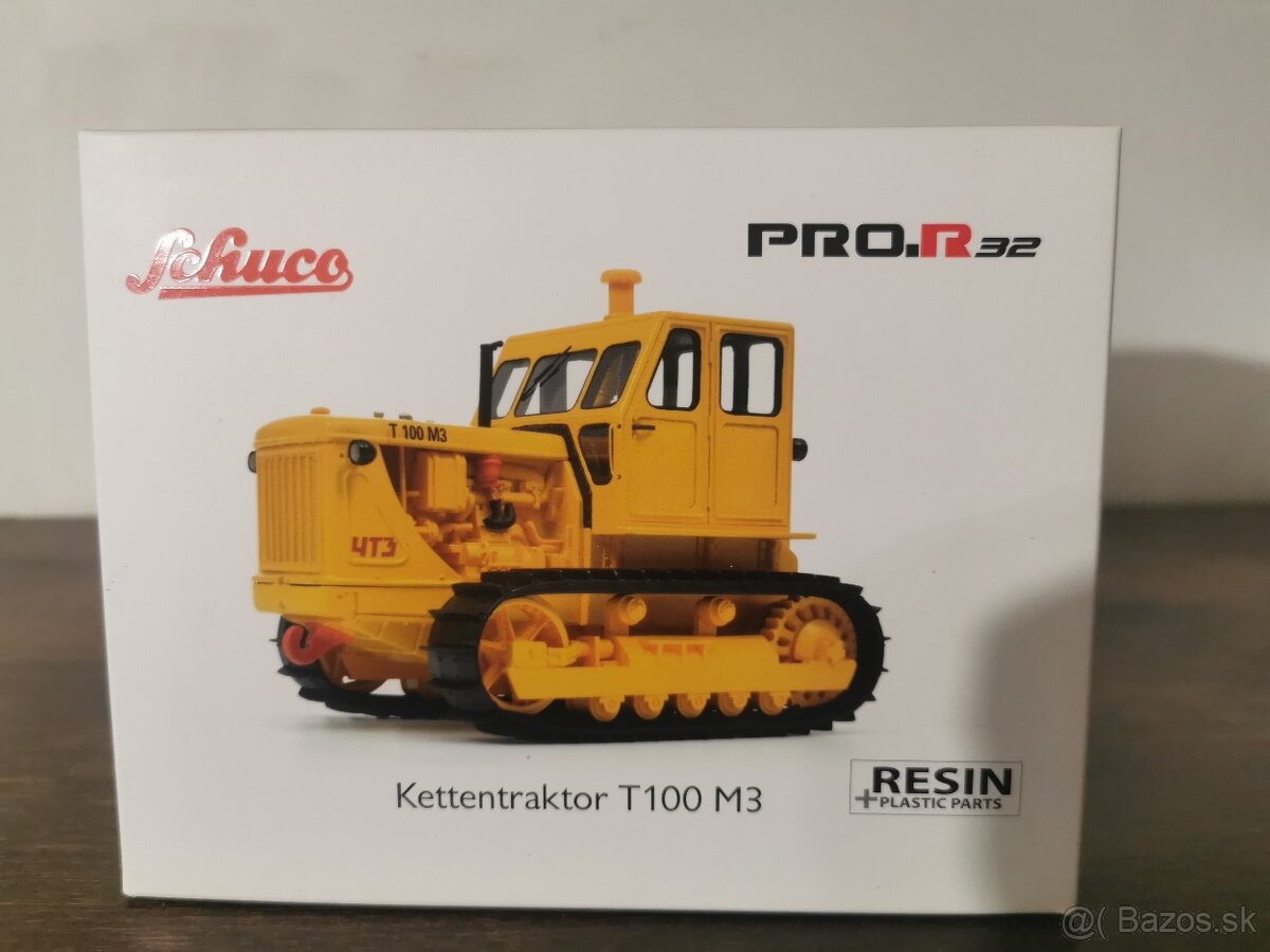 Model pásový traktor t 100 M3 1:32 schuco