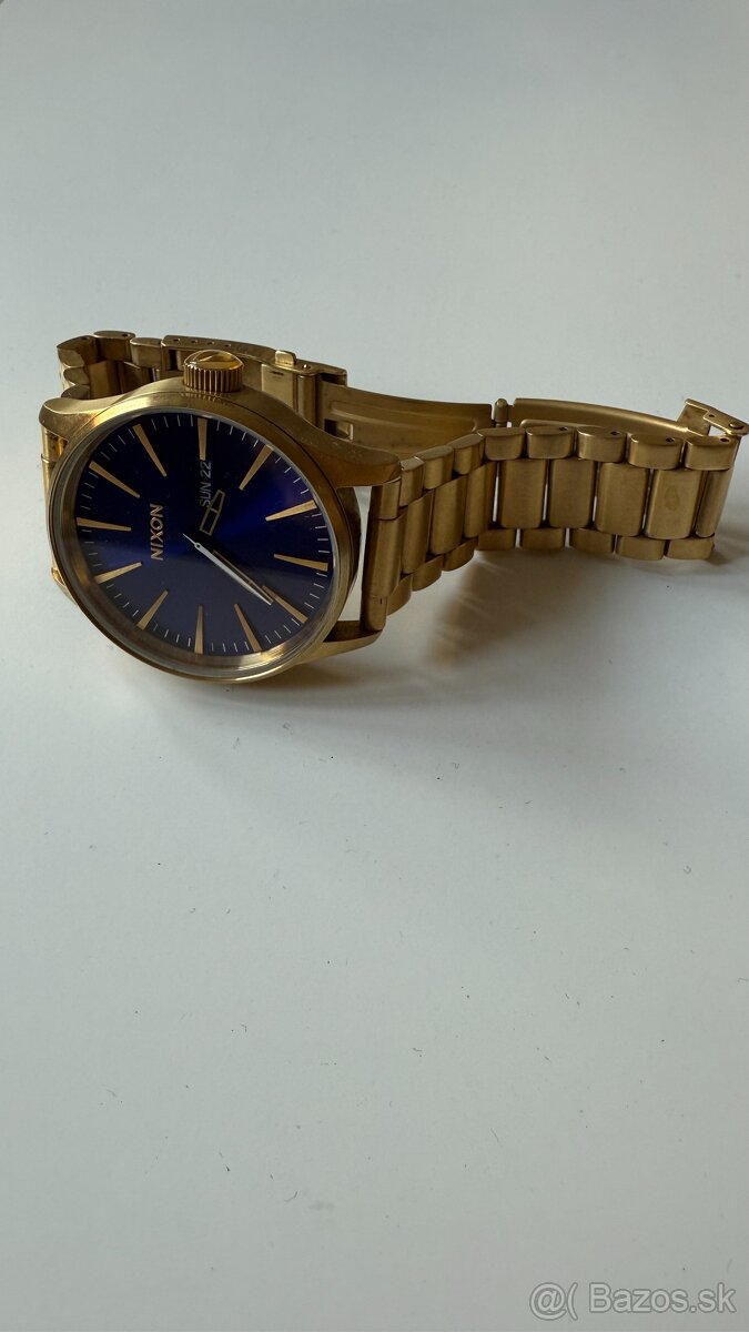 Hodinky Nixon Sentry SS  all gold/blue sunray