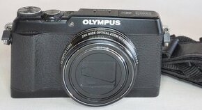 Olympus SH-1 s príslušenstvom.